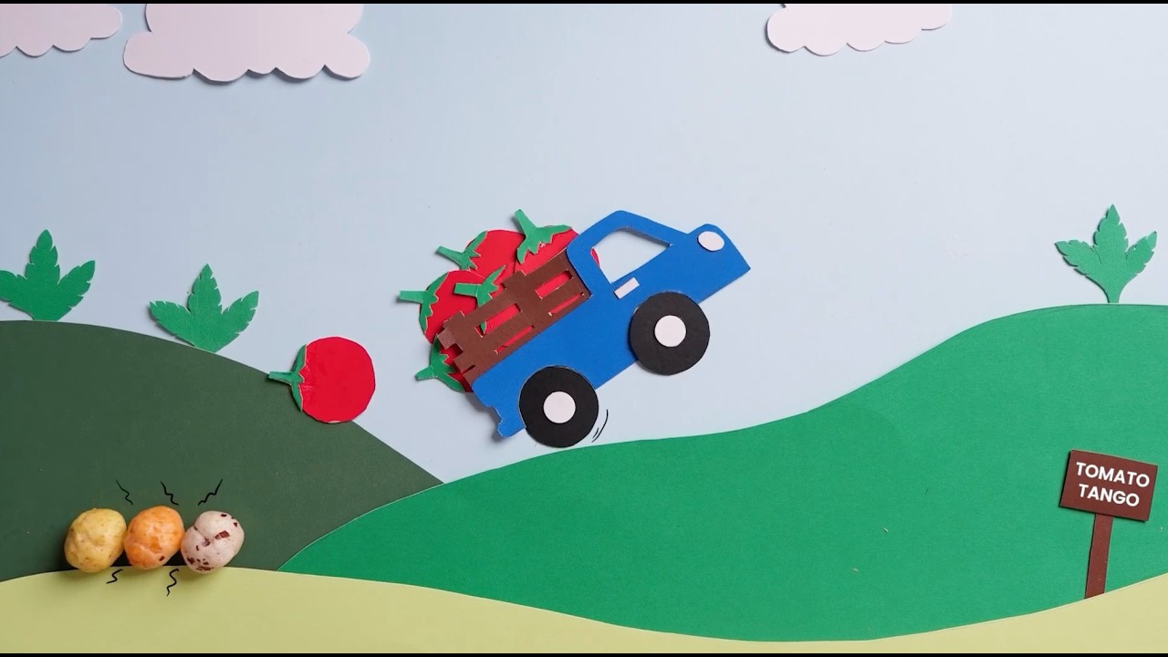 Handmade paper set from the Puffli film: a blue truck carrying tomatoes over green hills